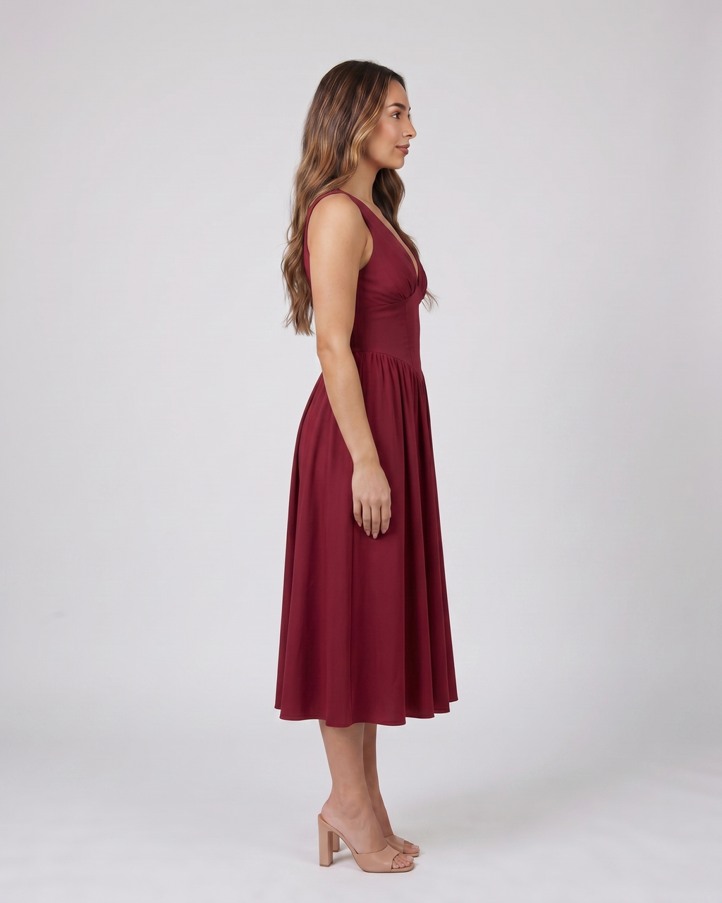 Side view of burgundy women's wedding guest deep v neck midi a line dress