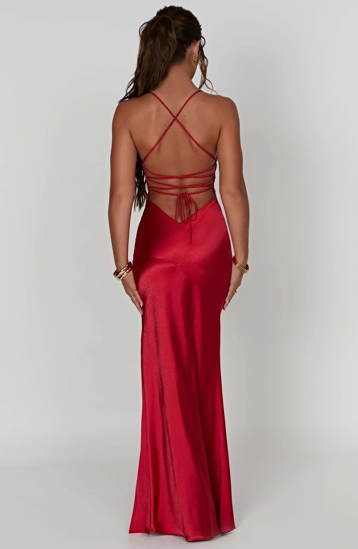 Back view of red satin maxi dress with lace-up straps and open back