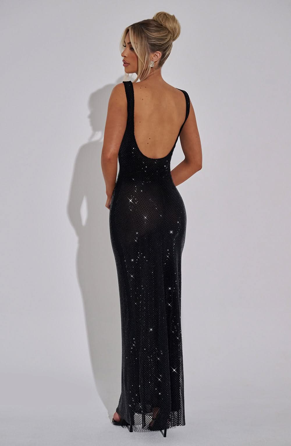Back view of black sequin maxi dress with open back detail