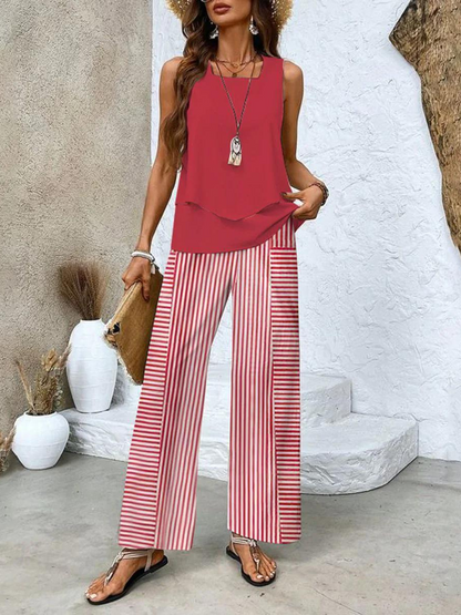 Red sleeveless layered blouse with red and white striped wide leg pants