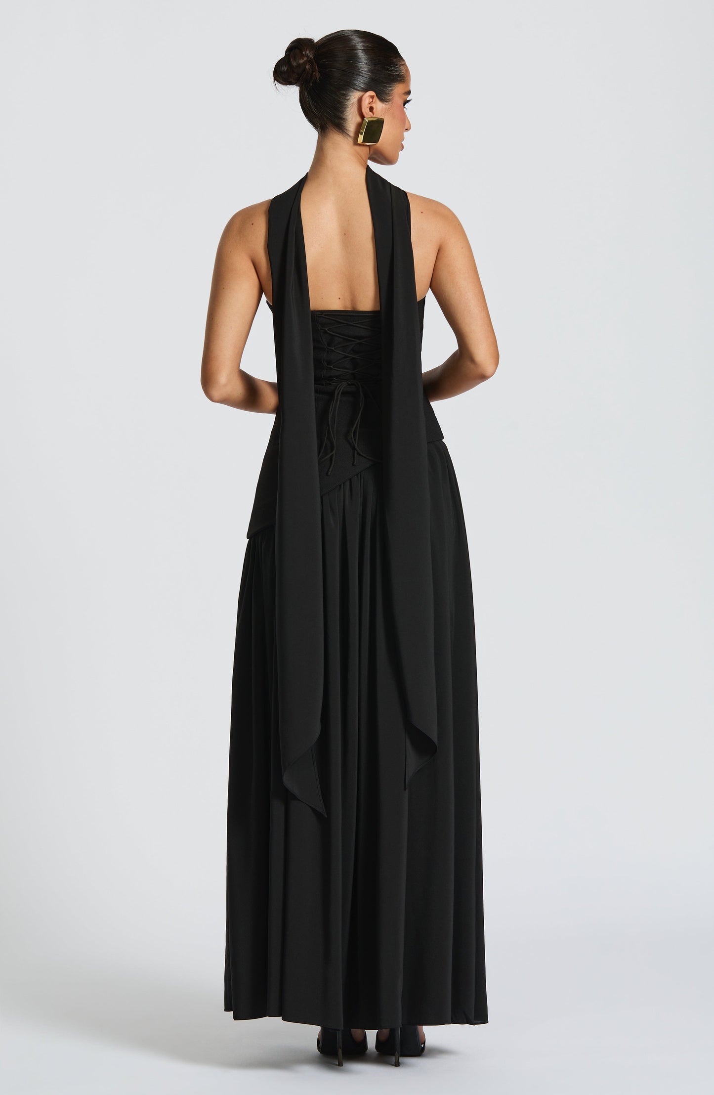 Black strapless asymmetric maxi dress back view with draped fabric detail