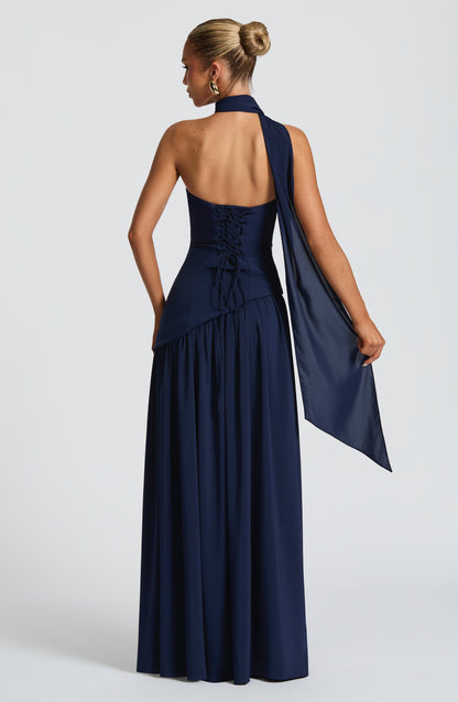 Navy halter strapless maxi dress back view with asymmetric waist and flowing skirt