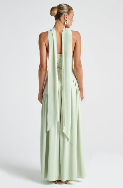 Sage green strapless maxi dress back view with flowing asymmetric skirt