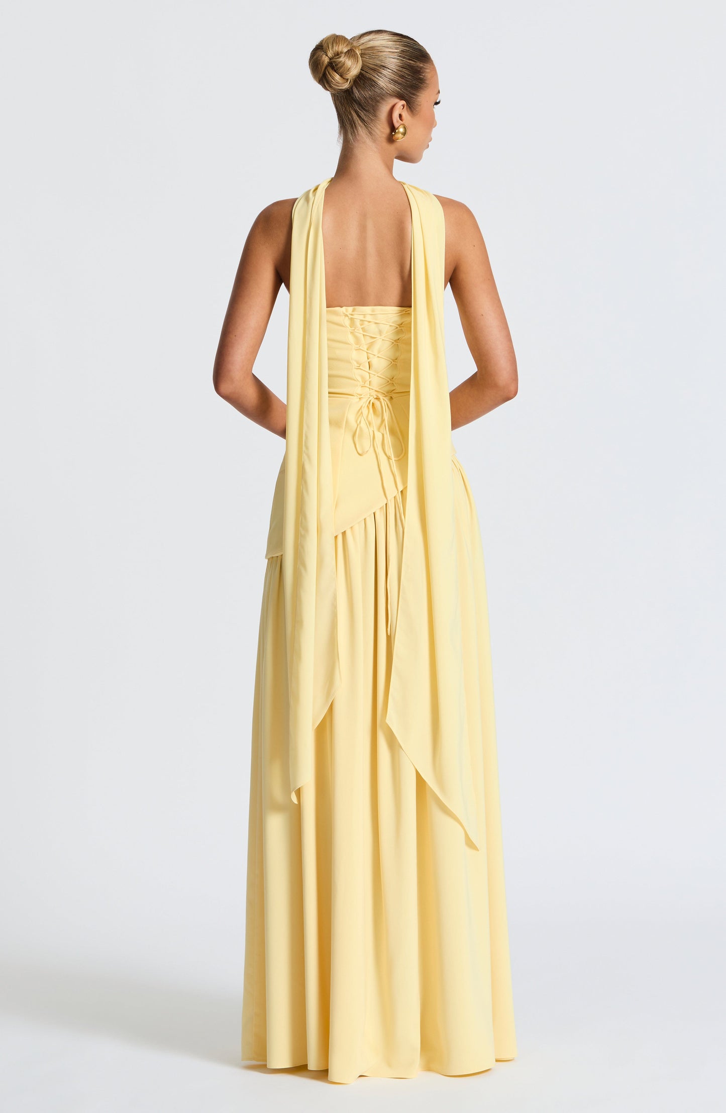 Pale yellow strapless maxi dress back view with lace-up corset detail