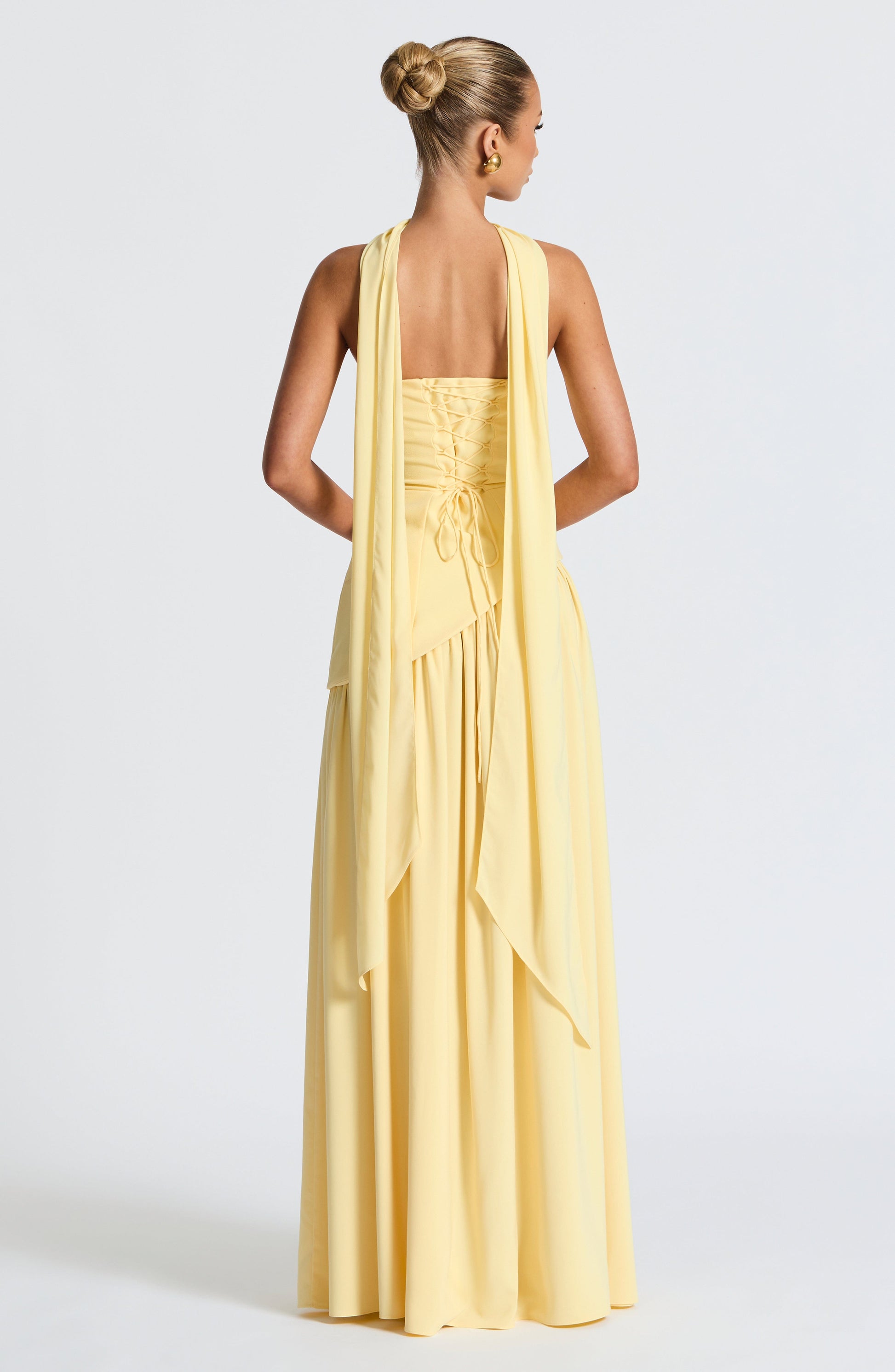 Pale yellow strapless maxi dress back view with lace-up corset detail