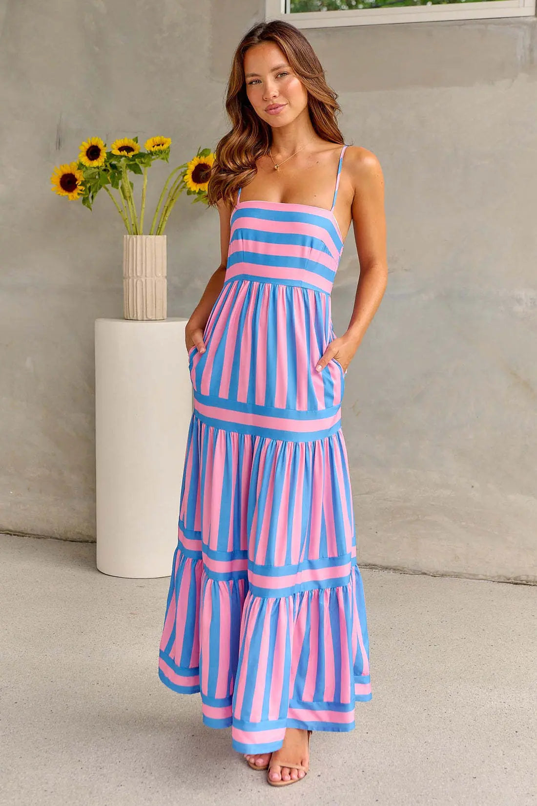Blue and pink striped spaghetti strap maxi dress with pleated bodice and tiered layers
