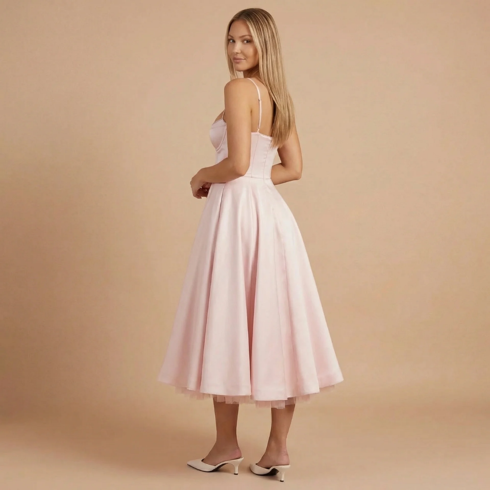 Back view of blush pink corset midi dress showing fitted bodice