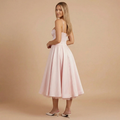Back view of blush pink corset midi dress showing fitted bodice