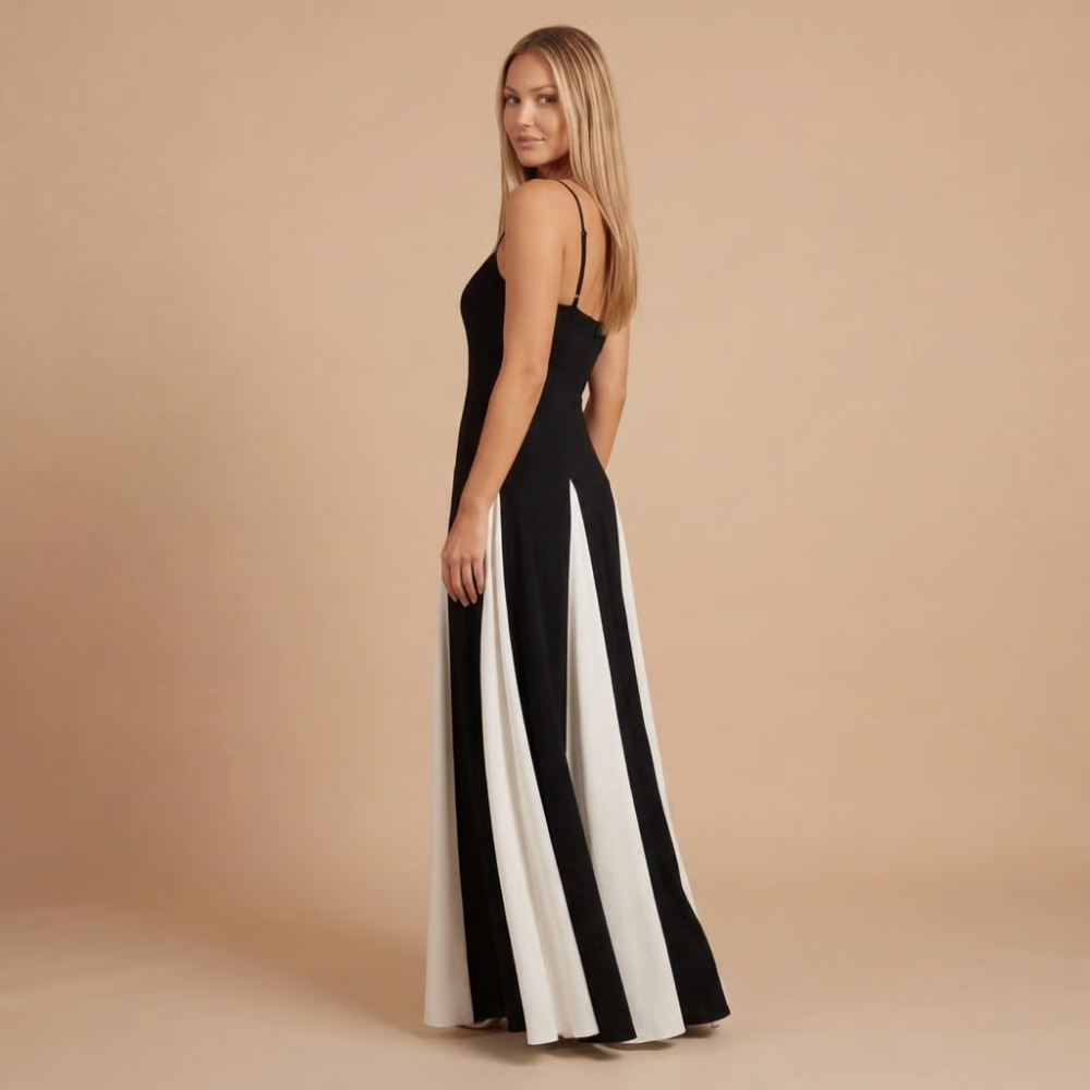 Side view of black and cream colorblock maxi dress with pleated panels