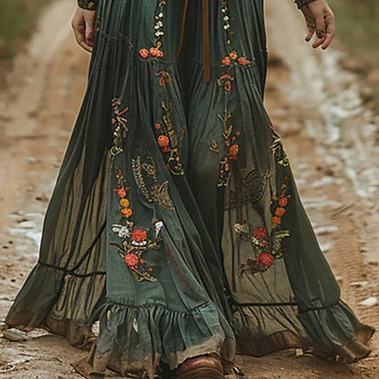 Full-length embroidered maxi dress skirt with red and gold floral motifs and ruffled hem