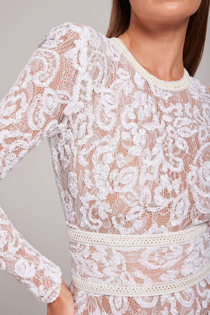 Close-up of white lace sleeve detail and cream studded belt on jumpsuit