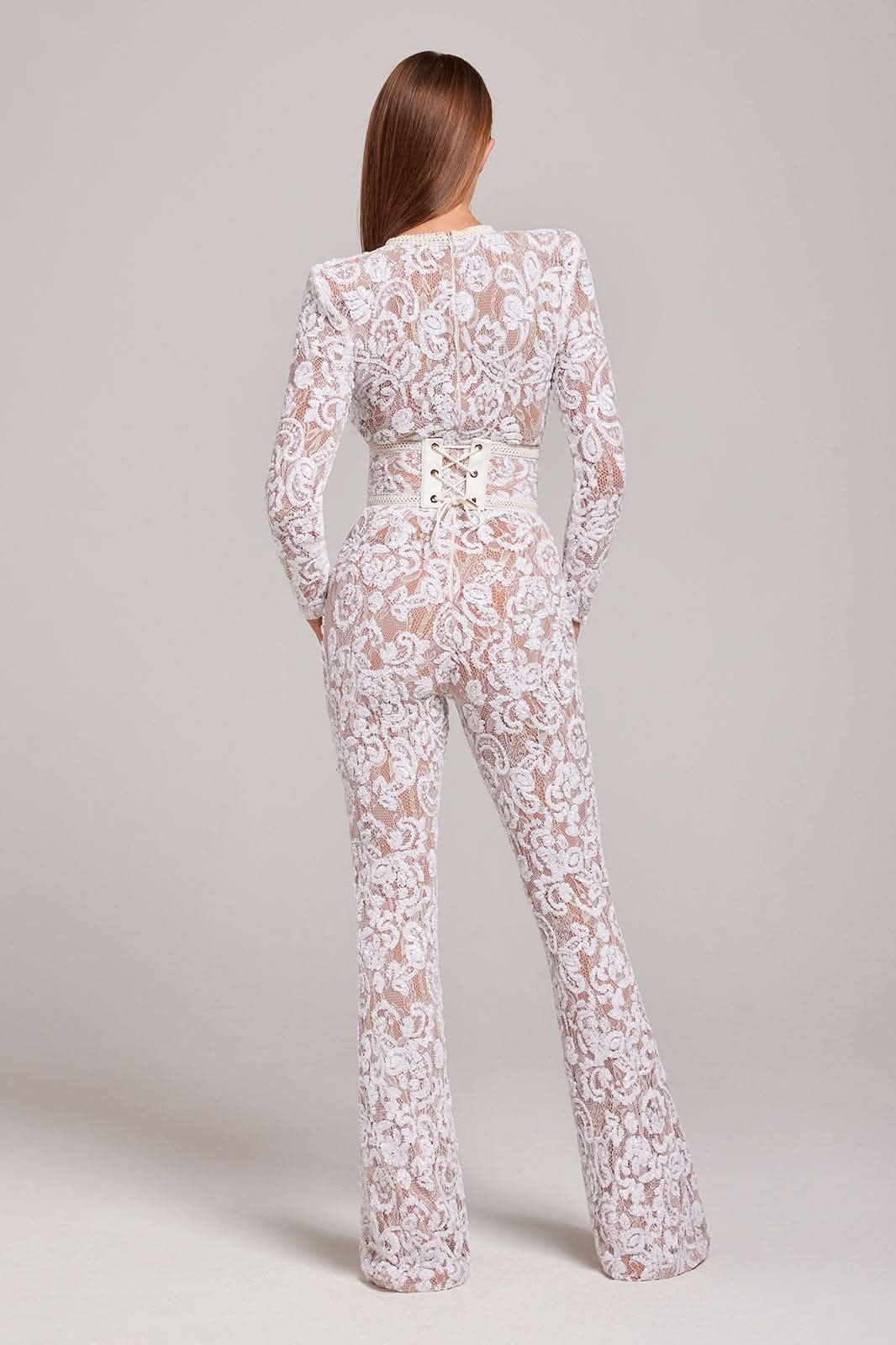 Back view of white lace jumpsuit with cream corset-style waist belt