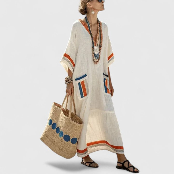 Women's boho V-neck maxi dress in cream with colorful striped trim and front patch pockets