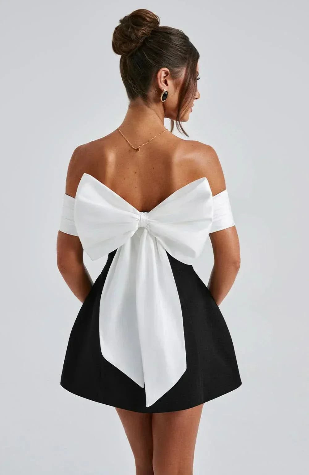 Back view of off-shoulder dress with white bow detail