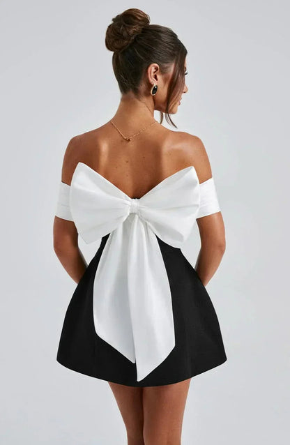 Back view of off-shoulder dress with white bow detail