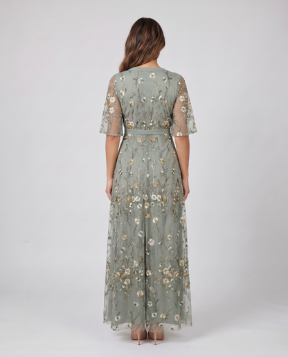 Back view of sage green embroidered wedding guest maxi dress